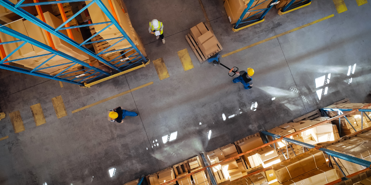 Warehouse floor with worker moving pallets - What’s New in Adhesives: Improve Your Application 