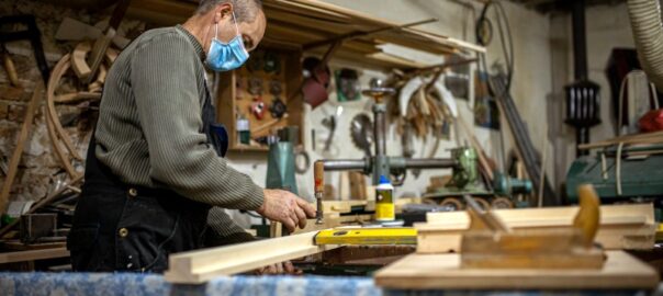 Carpenter wearing a mask while working with glue - Know the Dangers: Common Toxic Chemicals in Adhesives 