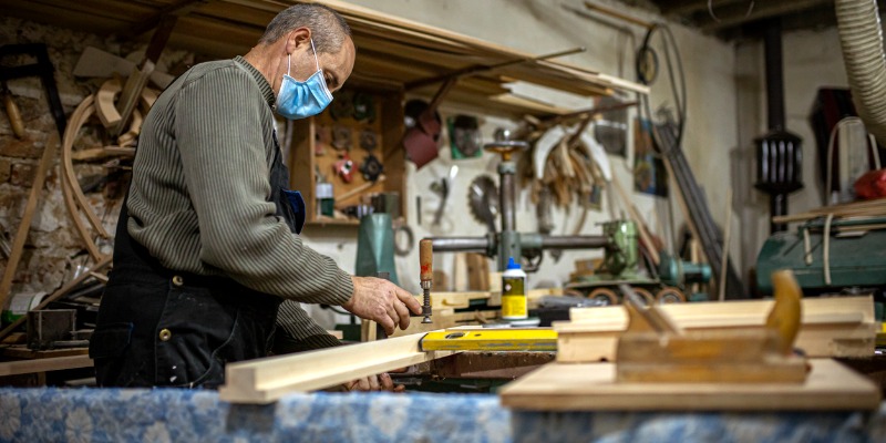 Carpenter wearing a mask while working with glue - Know the Dangers: Common Toxic Chemicals in AdhesivesÂ